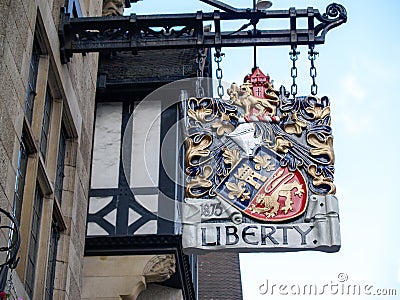 Ornate sign hanging off exterior wall of Liberty Department Store building Editorial Stock Photo