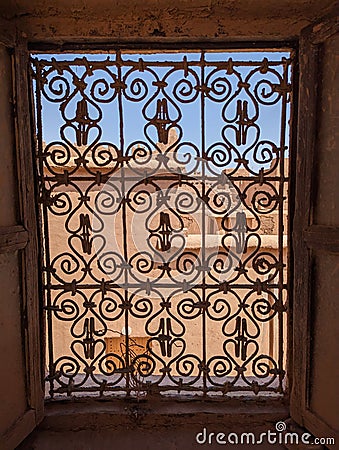 Ornate traditional window grid of a berber house ruin in the city center of Amezrou Stock Photo