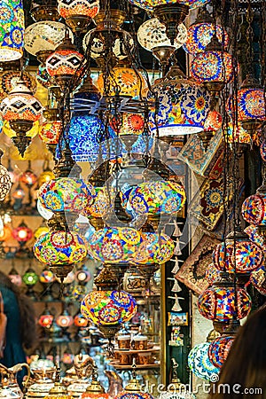 Ornate and vibrant collection of Turkish lamps hangs from the window of an authentic market Stock Photo