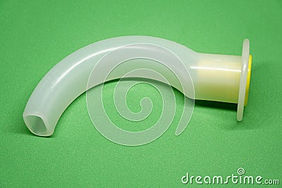 Oropharyngeal Airway tube with connector isolated on green background Stock Photo