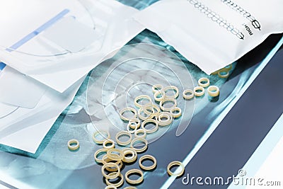 Orthodontic latex braces rings laying on jaw xray Stock Photo