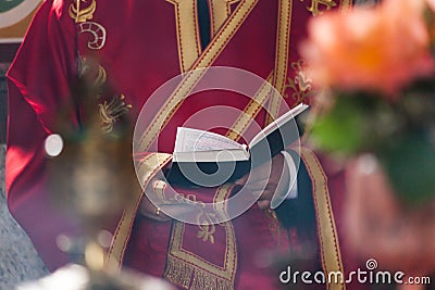 Orthodox baptism in the church priest reading from book with text for baptism close Stock Photo