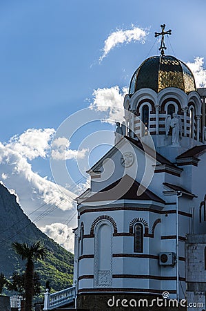 Orthodox cathedral behind palm trees in the seaside city Stock Photo