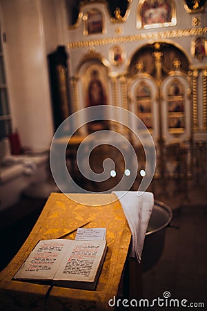Orthodox Christian Cross, Holy Bible and utensils in the church. Epiphany ceremony rite. Stock Photo