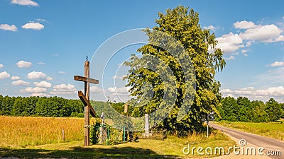 Orthodox cross standing near the road. Stock Photo