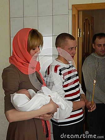 Orthodox infant baptism ceremony at home in Belarus. Editorial Stock Photo