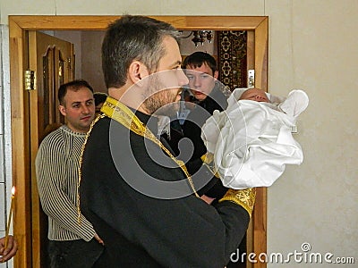 Orthodox infant baptism ceremony at home in Belarus. Editorial Stock Photo