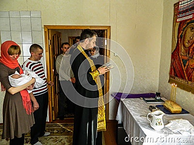 Orthodox infant baptism ceremony at home in Belarus. Editorial Stock Photo