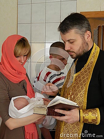 Orthodox infant baptism ceremony at home in Belarus. Editorial Stock Photo