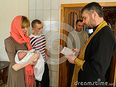 Orthodox infant baptism ceremony at home in Belarus. Editorial Stock Photo