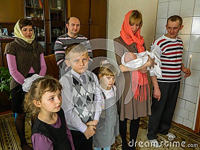 Orthodox infant baptism ceremony at home in Belarus. Editorial Stock Photo