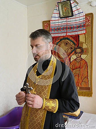 Orthodox infant baptism ceremony at home in Belarus. Editorial Stock Photo