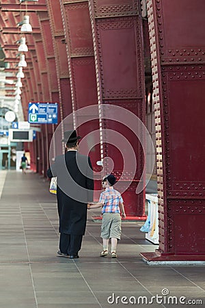 An orthodox with a small child Editorial Stock Photo
