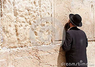 Orthodox Jewish Man prays at the western wall Editorial Stock Photo
