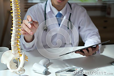 Orthopedist uses tablet at workplace Stock Photo