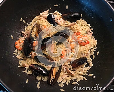 Orzo Palermo italiano with squid, shrimp and mussels. Stock Photo