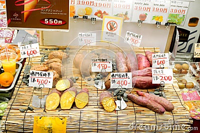 Japanese sweet potato slice and steam on bamboo grille with Japanese name and price labels. Editorial Stock Photo