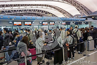 Image of many tourists waiting for check in front of airline counter in the airport Editorial Stock Photo