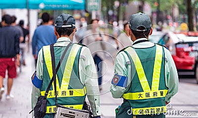 OSAKA, JAPAN - MAY 2016: Police officers along city streets. The Editorial Stock Photo