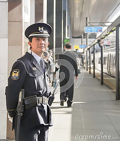 Osaka - 2010: Japanese officer in a train station Editorial Stock Photo