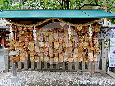 Wooden votive plaque Ema`s hanging at Tsuyunoten Shrine Editorial Stock Photo