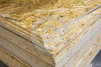 OSB - Oriented strand board. Stacked OSB sheets. Sheet material for the construction of frame houses Stock Photo