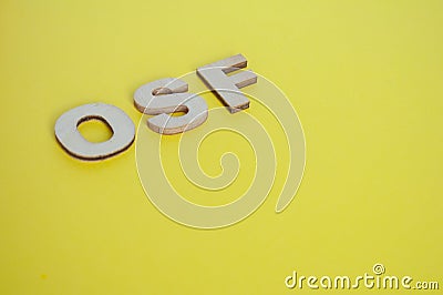 OSF wooden letters representing Open Science Framework on yellow background Stock Photo
