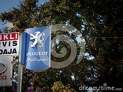 OSIJEK, CROATIA - SEPTEMBER 21, 2023: Peugeot Motocycles logo on an sign of a scooter & bike dealership. Peugeot Motocycles is the Editorial Stock Photo