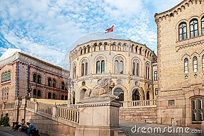Oslo, Norway-August 1, 2013: Stortinget Parliament building Oslo Norway with beautiful fine light clouds. People rest on the Editorial Stock Photo