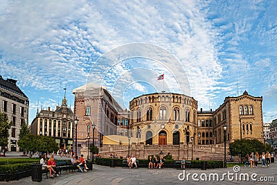 Oslo, Norway-August 1, 2013: Stortinget Parliament building Oslo Norway with beautiful fine light clouds. People rest on the Editorial Stock Photo