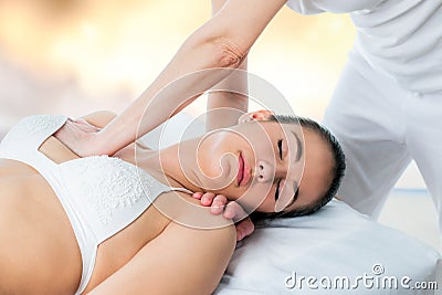 Osteopath applying pressure on female chest. Stock Photo