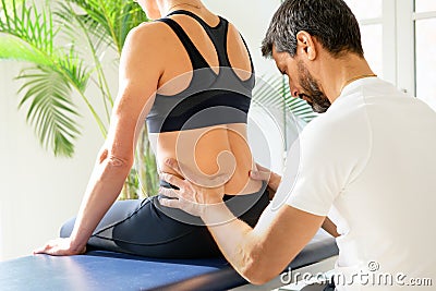 Osteopath doing a lumbosacral evaluation Stock Photo