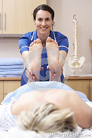 Osteopath treating female client Stock Photo