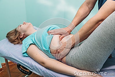 Osteopathic belly massage young woman Stock Photo