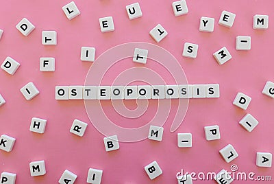 Osteoporosis word made of square letter word on pink background. Stock Photo