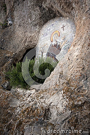 OSTROG, Montenegro: Cave and icon of Saint Venerable Isaiah Onogosha in rocky Serbian Orthodox Christian monastery Ostrog in mount Stock Photo