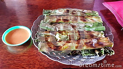 Otak otak Palembang. Traditional Palembang snack of grilled fish cakes wrapped with banana leaf. Stock Photo