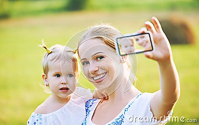 Other , baby daughter photographing selfie themselves by mobile phone in summer Stock Photo