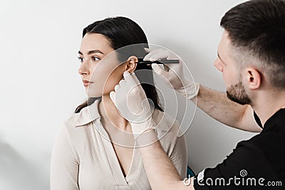 Otoplasty markup for surgical reshaping of the pinna, or outer ear for correcting an irregularity and improving Stock Photo