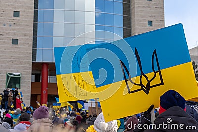 Rally with in support of Ukraine against war. Protest and march against Russian invasion. People with Ukranian flags in Editorial Stock Photo