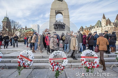 Crowd of Canadian war Veterans standing behind funeral wreath on National War memorial, on remembrance day Editorial Stock Photo