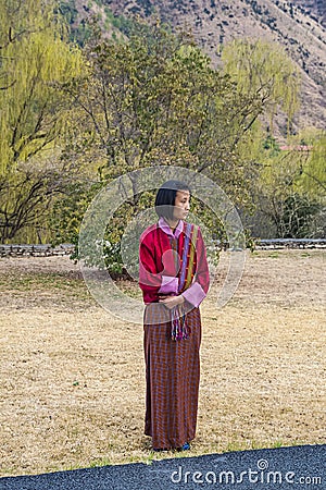 Oung Bhutanese girl in traditional women dress named kira, wonju long-sleeved blouse and a short jacket toego Editorial Stock Photo