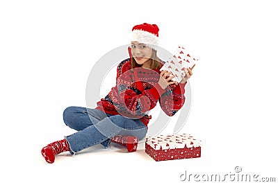 Oung woman puts her ear to the present wrapped in red paper, isolated on white Stock Photo