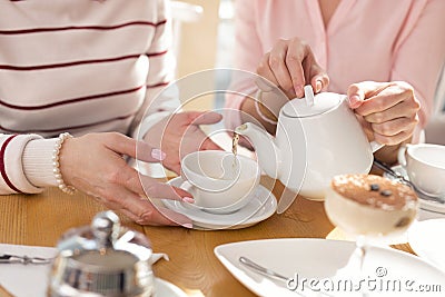 Caring girl having lunch with her granny Stock Photo
