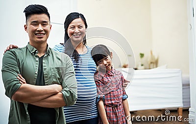 Our family keeps growing with love. Portrait of a happy family bonding together at home. Stock Photo