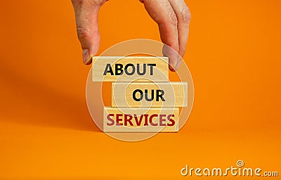 About our services symbol. Wooden blocks tower with words `about our services`. Male hand. Beautiful orange background. Copy spa Stock Photo