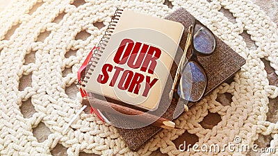 Our story words on notebook, glasses, pen. Business startup concept Stock Photo