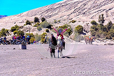Tourists Horse riding services at Mount Bromo. Editorial Stock Photo