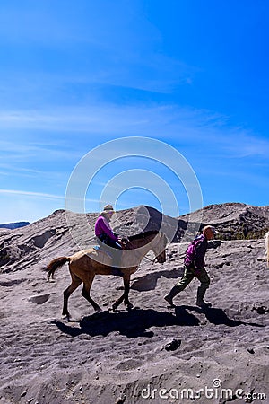 Tourists Horse riding services at Mount Bromo. Editorial Stock Photo