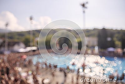 Out of focus, defocused shot, group of unrecognizable people outdoors, large crowd, swimming pool, Stock Photo
